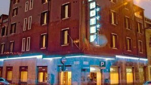 A multi-story building with a prominent 'P' sign indicating a parking area. - Piccolo Hotel (Milan)
