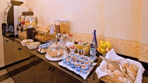 A buffet with various food items, including pastries, fruits, and beverages. - Piccolo Hotel (Milan)