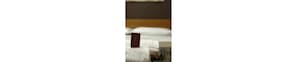 A close-up of a white pillow with a small, dark-colored tag attached to it. - Hotel Bogart (Milan)
