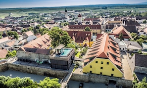 A town with historic buildings, a prominent church, and a castle-like structure.
