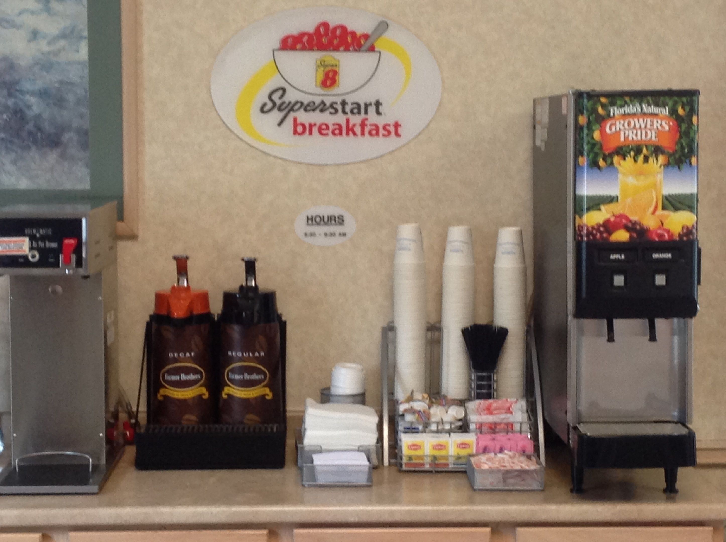 A breakfast counter with a sign reading "Superstart breakfast," coffee dispensers, and a juice dispenser.