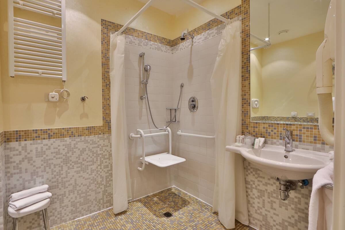 combined shower/bathtub, designer toiletries, hair dryer, bathrobes