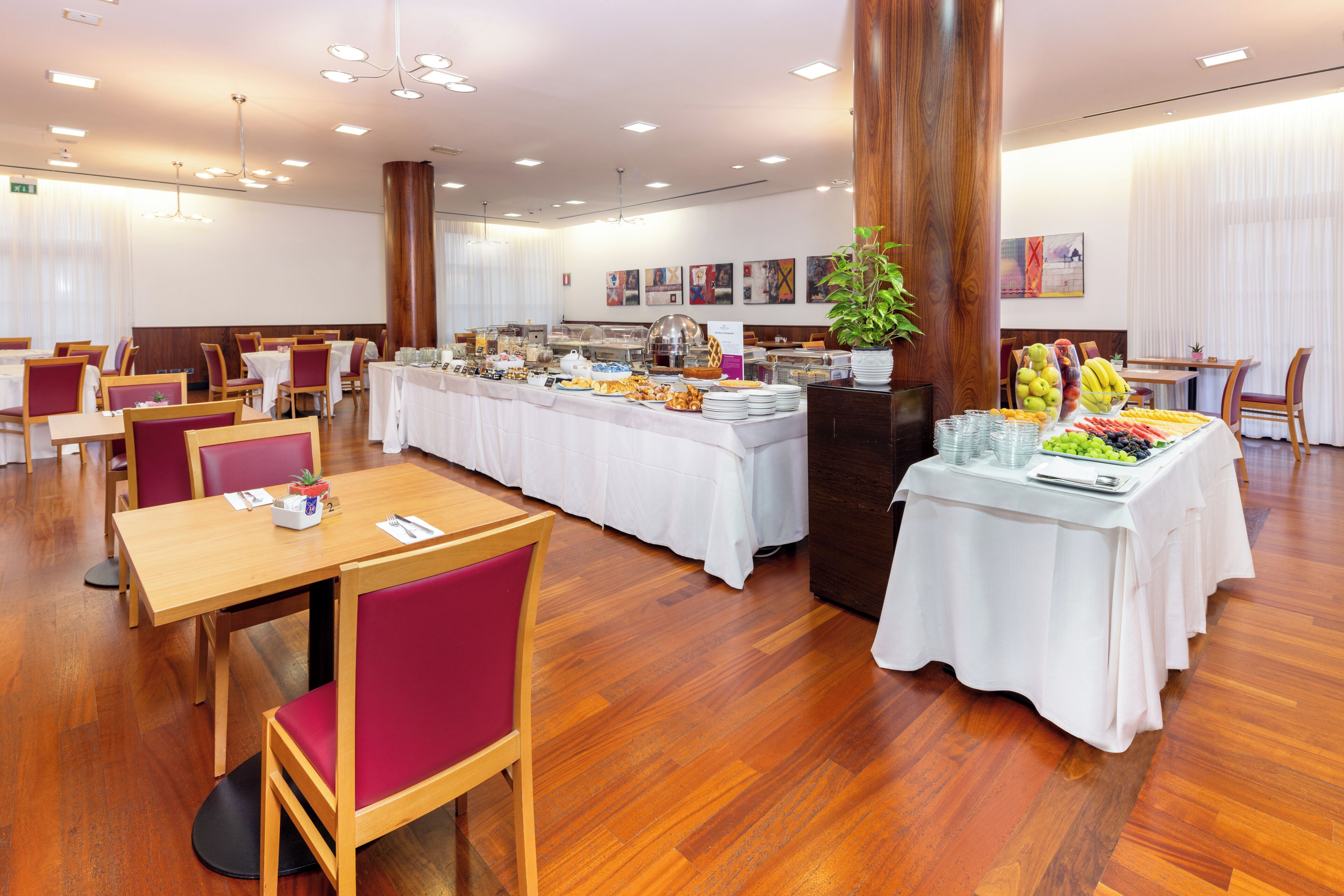 A dining area with tables, chairs, and a buffet.