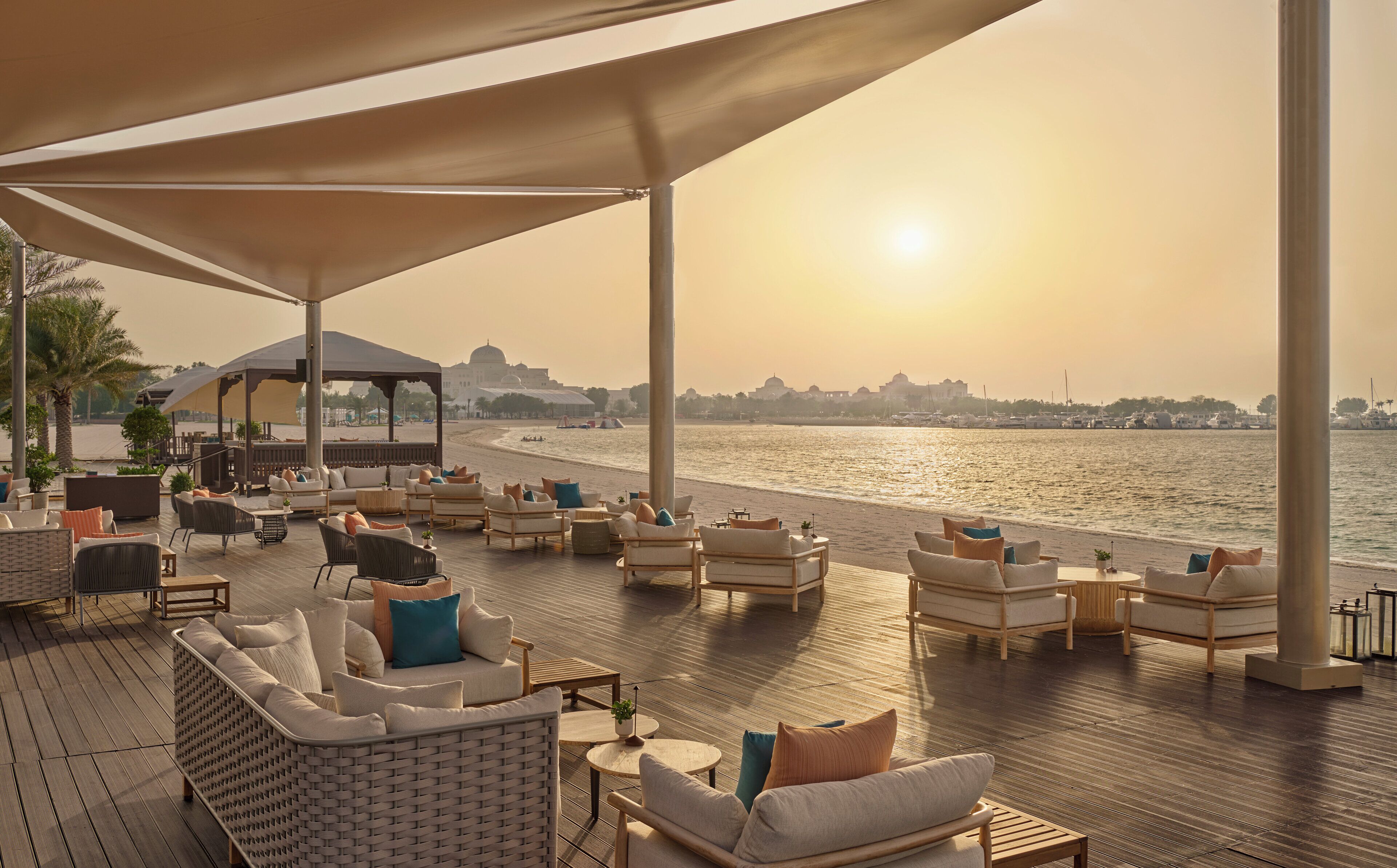 A deck with outdoor seating and a view of the water.