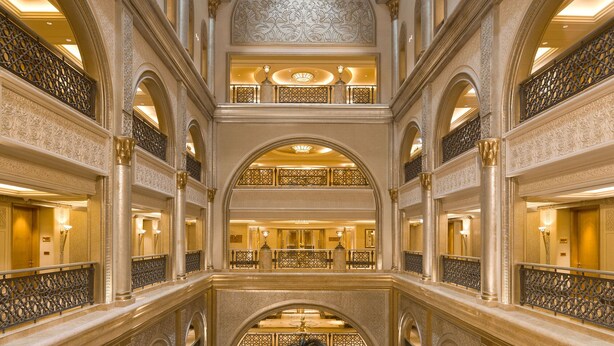 A multi-level atrium with ornate columns, a central palm tree, and a reflective ceiling. - Emirates Palace Mandarin Oriental, Abu Dhabi (Abu Dhabi)