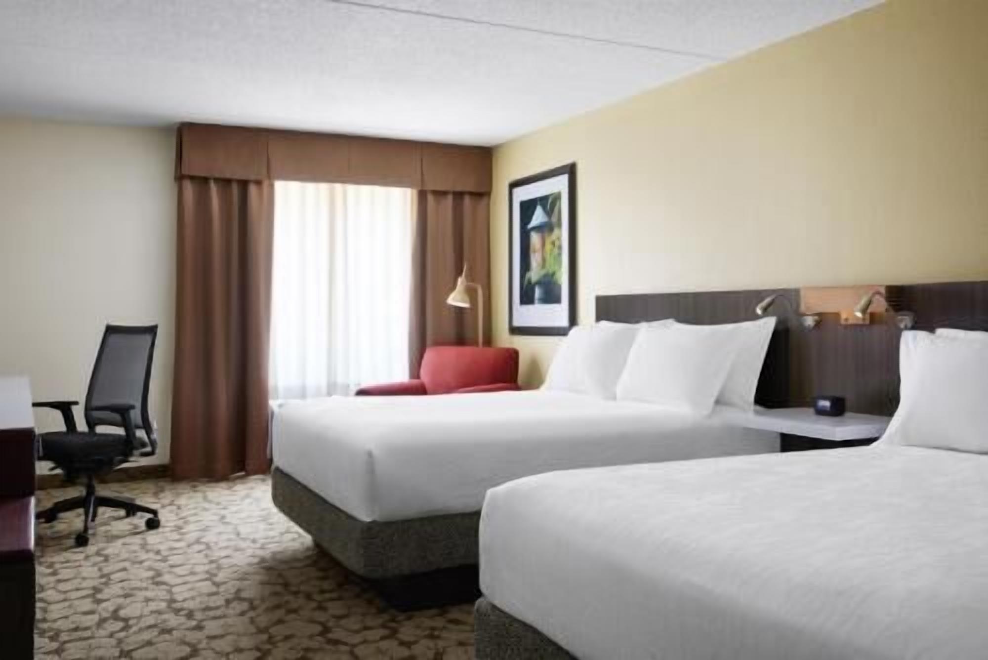Premium bedding, desk, laptop workspace, blackout drapes