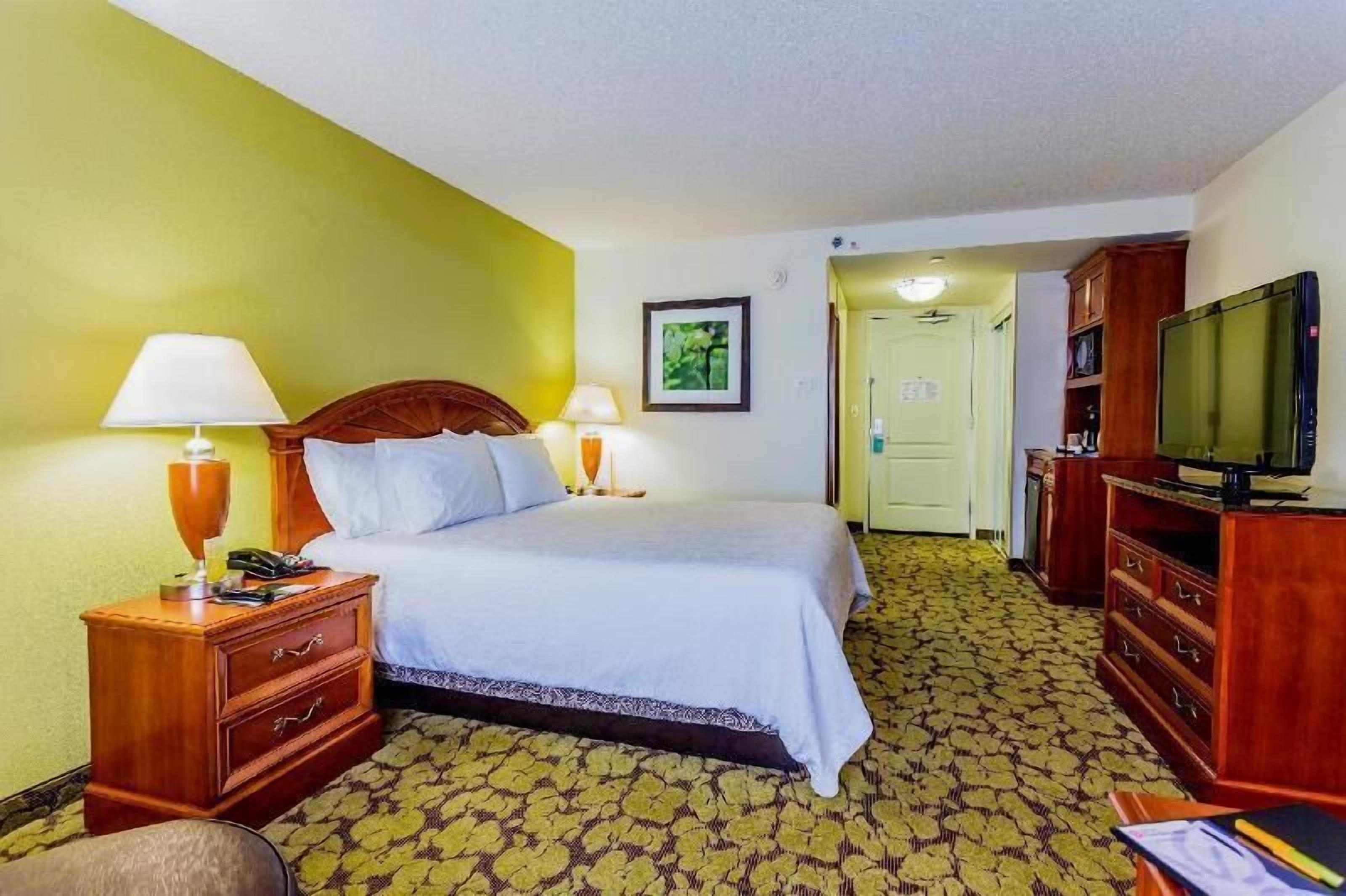 Premium bedding, desk, laptop workspace, blackout drapes