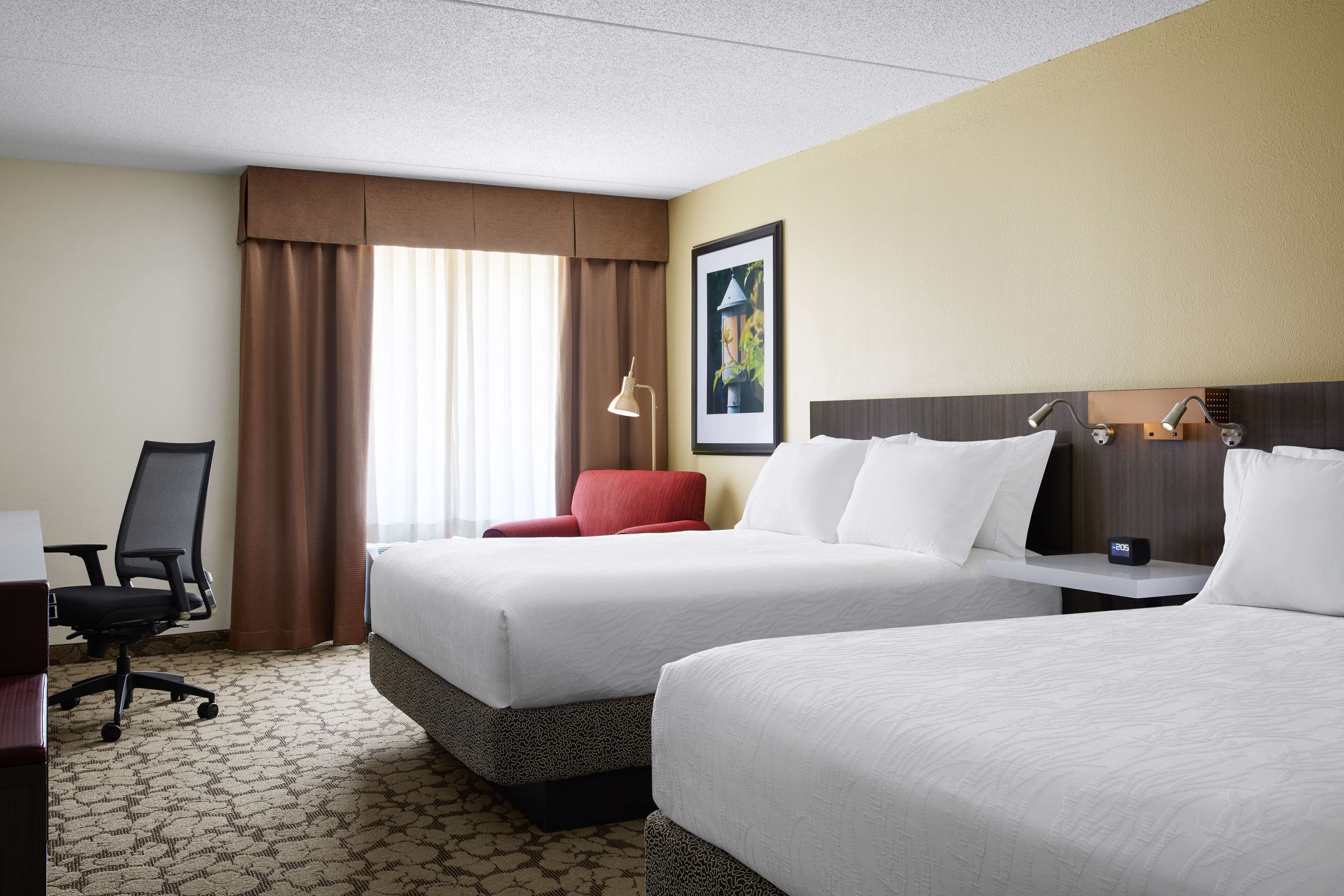 Premium bedding, desk, laptop workspace, blackout drapes