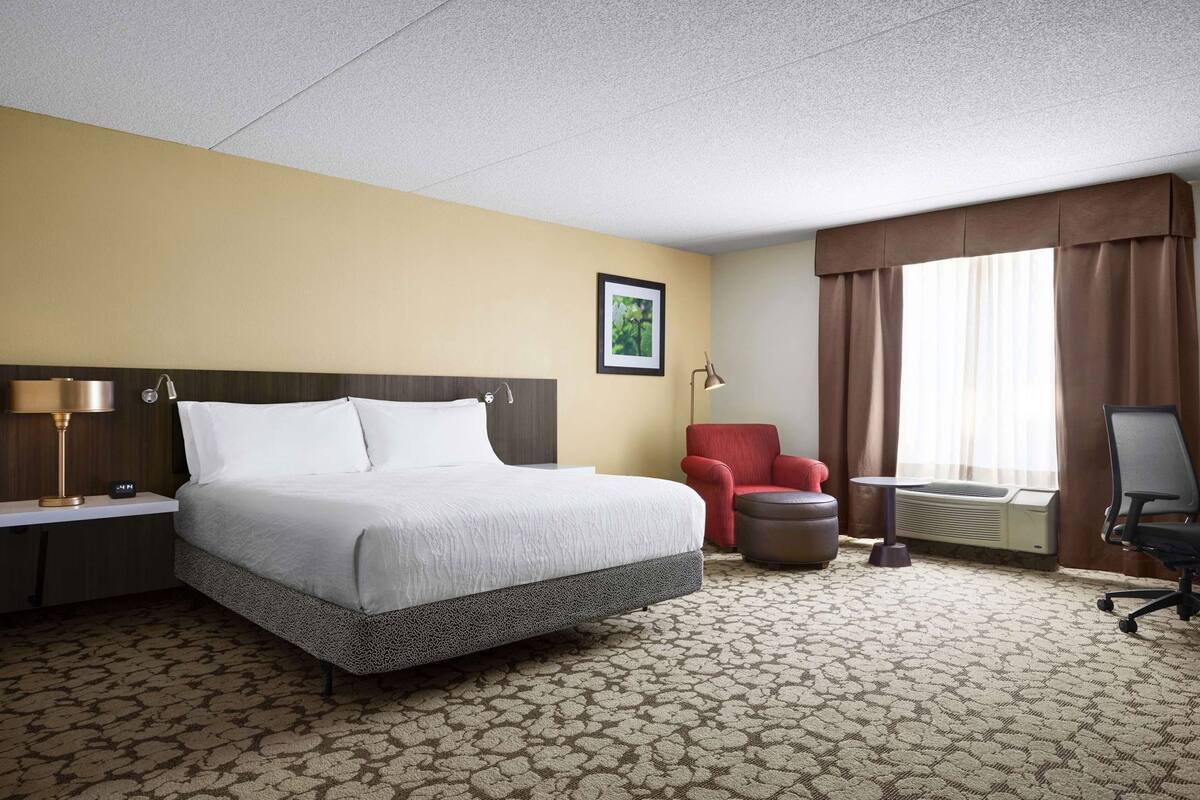 Premium bedding, desk, laptop workspace, blackout drapes