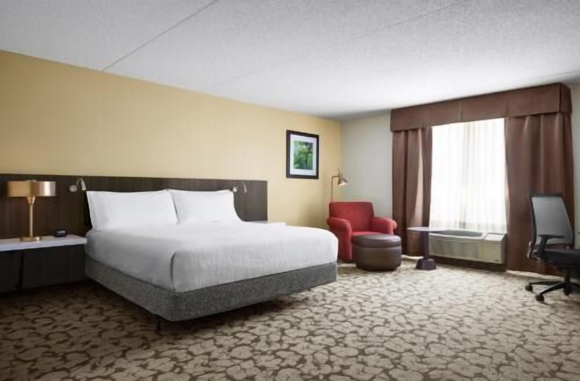 Premium bedding, desk, laptop workspace, blackout drapes