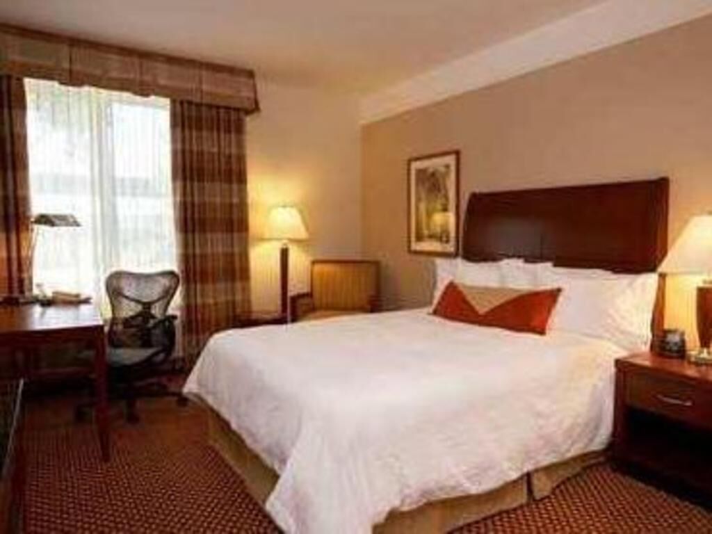 Premium bedding, desk, laptop workspace, blackout drapes