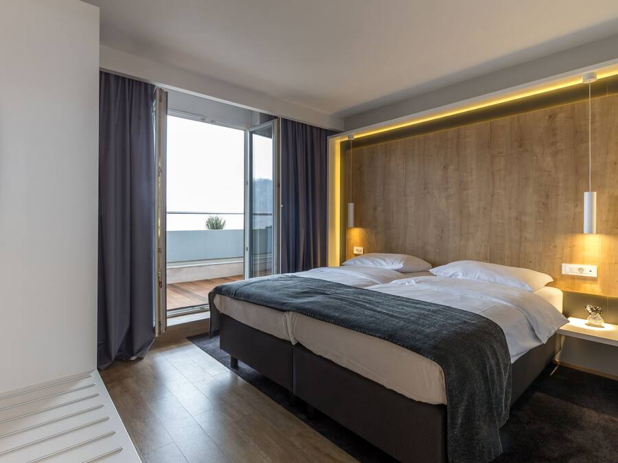 Suite – junior | Senger med overmadrass, safe på rommet og skrivebord