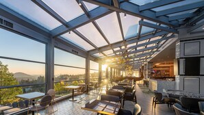A modern restaurant with a glass ceiling, offering views of the surrounding landscape. - The Westin Bear Mountain Golf Resort & Spa, Victoria (Victoria)