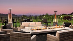 An outdoor seating area with a fire feature and a mountain view. - The Westin Bear Mountain Golf Resort & Spa, Victoria (Victoria)