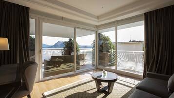 A modern room with a balcony, a round table, and a sofa.