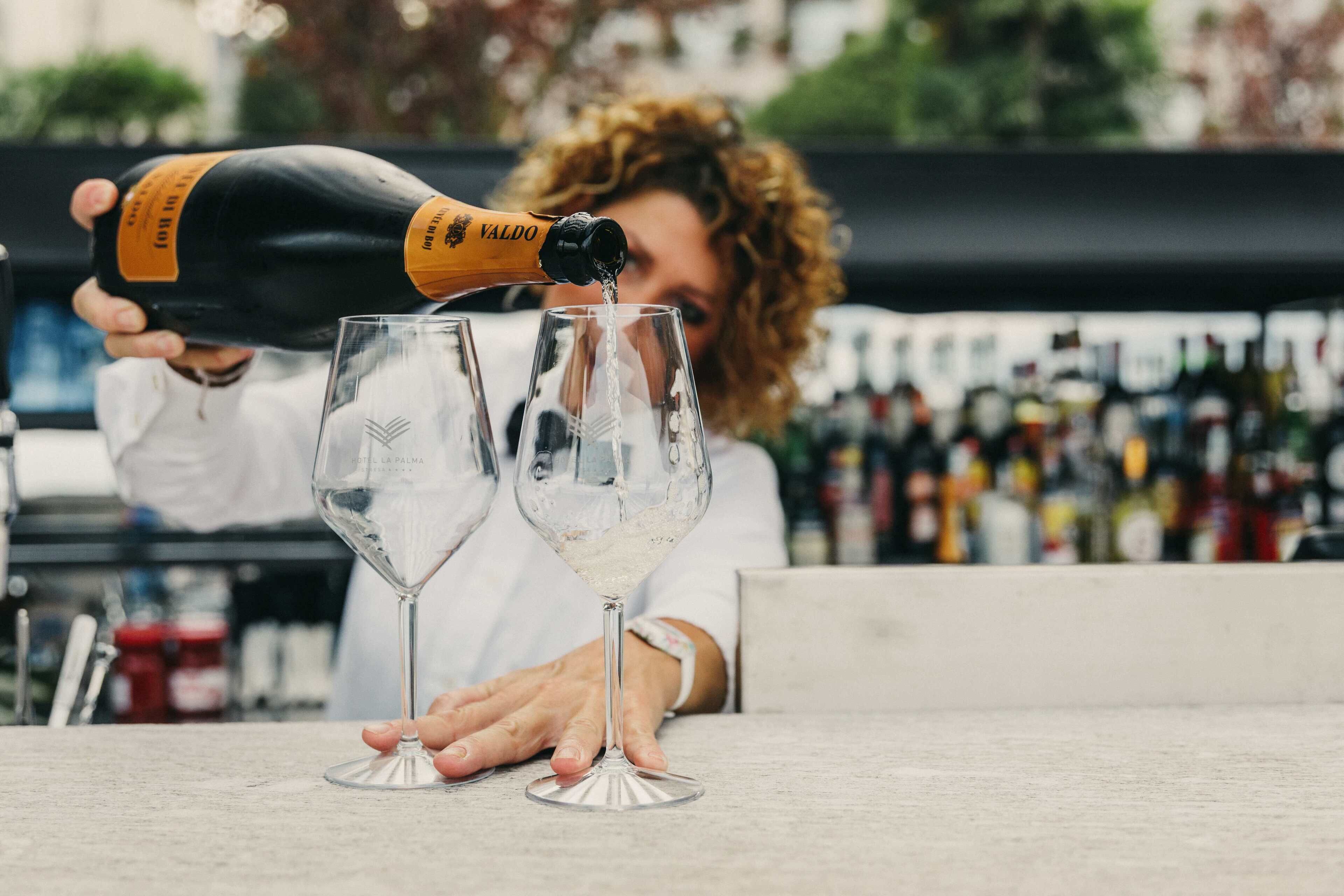 A person pouring champagne into a glass.