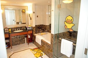 A bathroom with a marble sink, a bathtub, and a glass shower enclosure.