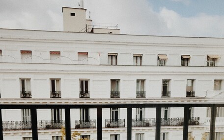A table with food and drinks on a balcony overlooking a cityscape.
