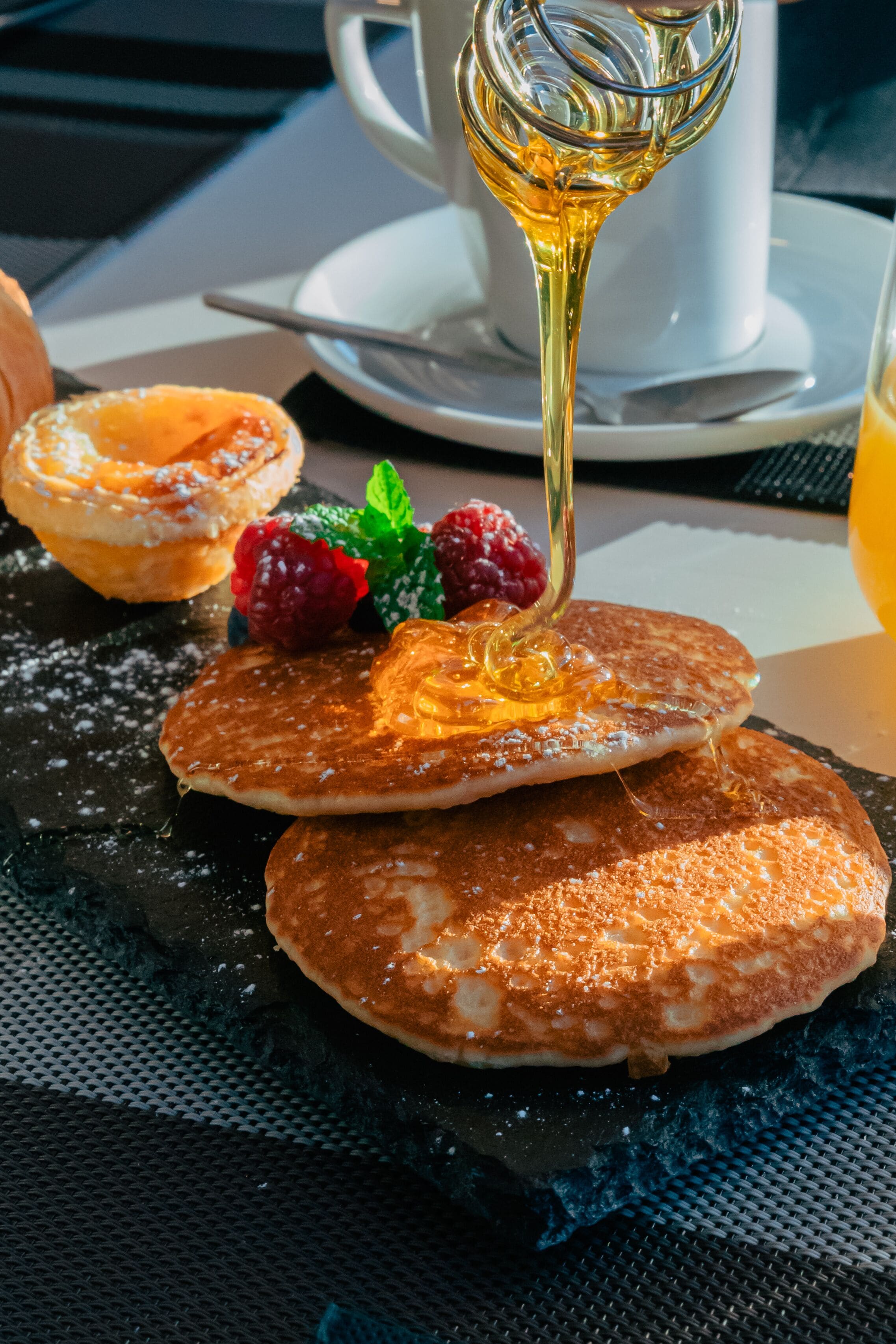Pancakes with syrup and berries on a plate.