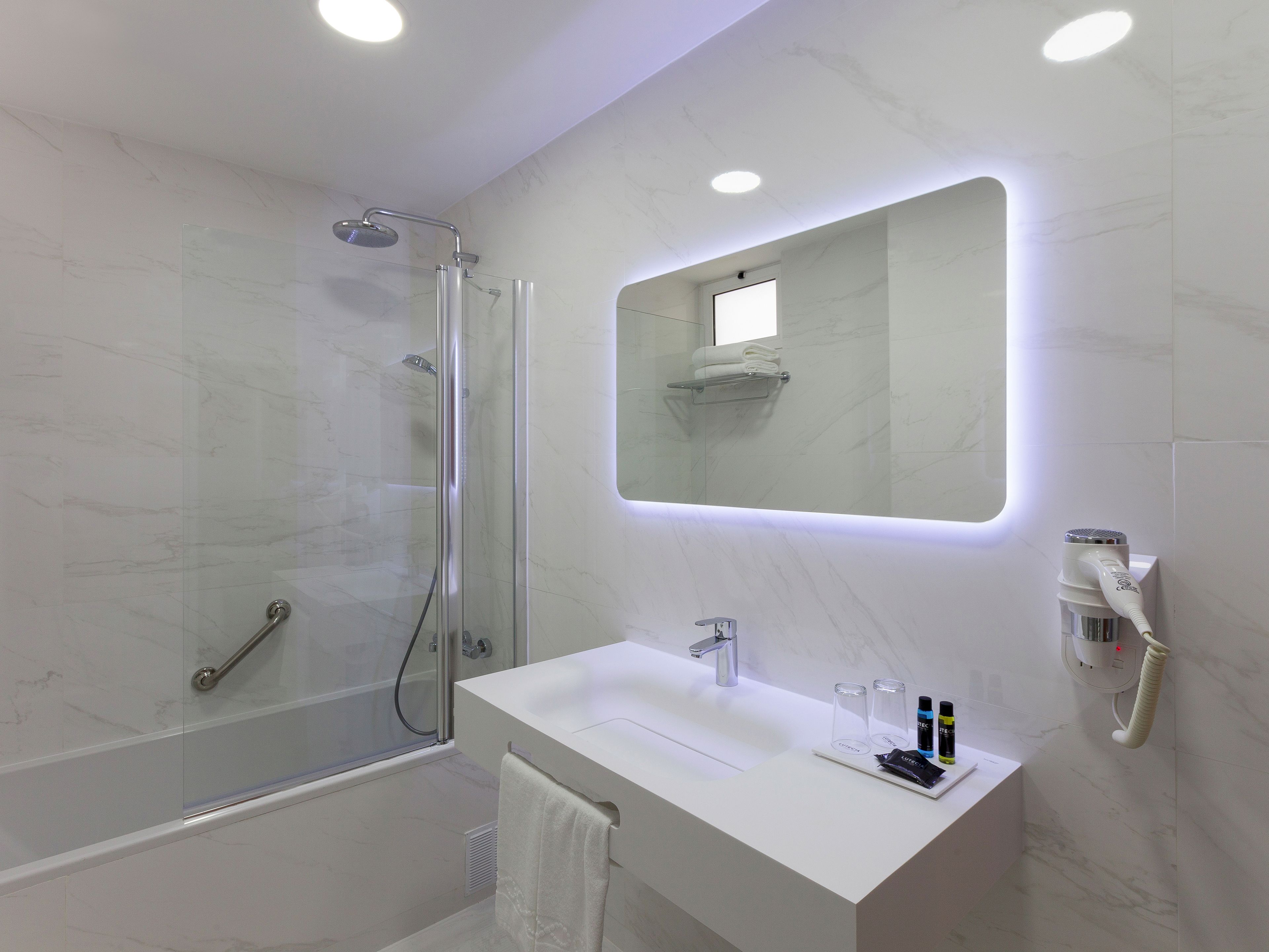 bathtub, designer toiletries, hair dryer, bidet