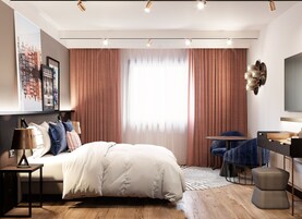 A modern bedroom with a large bed, a desk, and a chair.