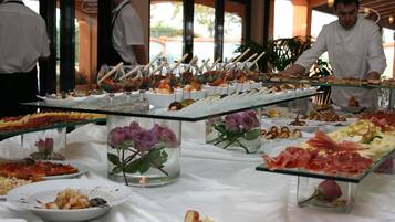 Un buffet con diversi cibi e composizioni floreali.