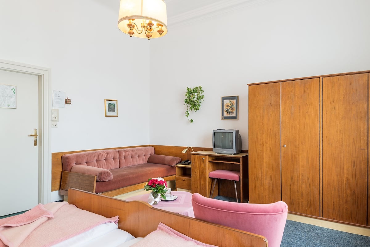 Triple Room, Private Bathroom | Living area | 32-inch TV with cable channels