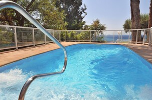 Outdoor pool, open 9 AM to 9 PM, pool umbrellas, pool loungers