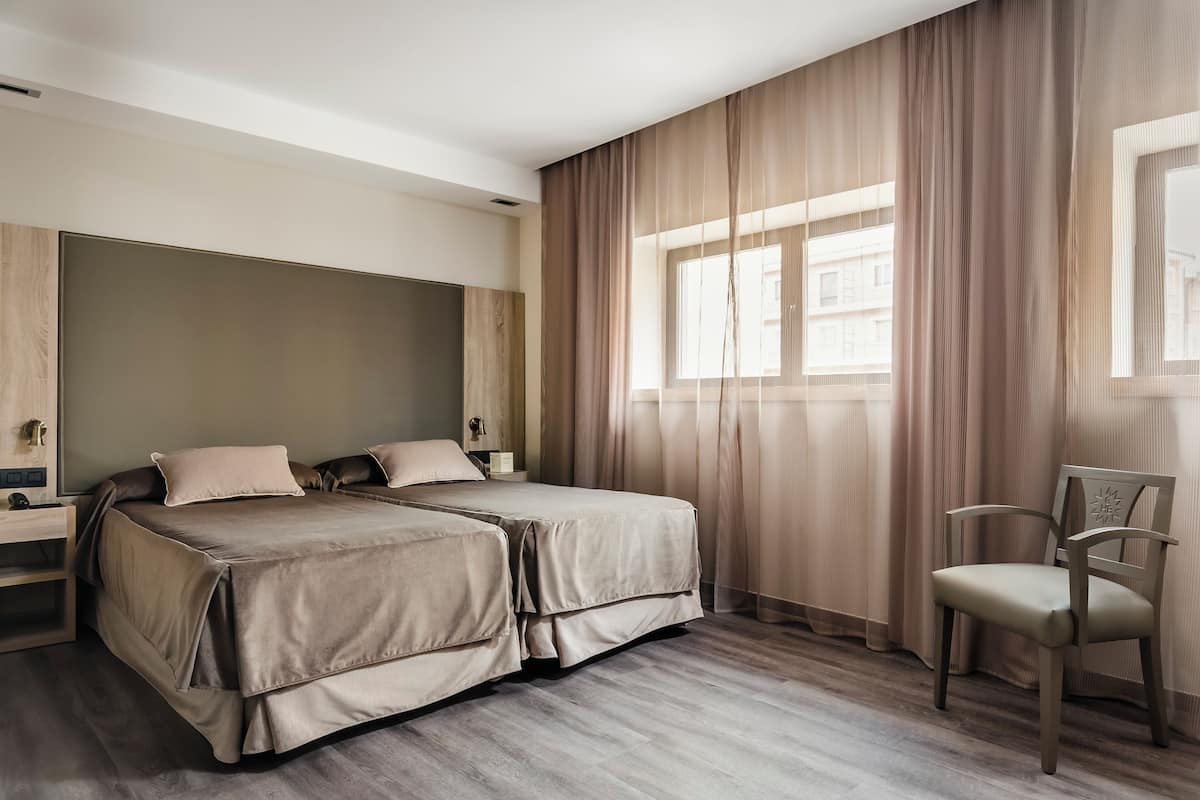 Down comforters, pillowtop beds, in-room safe, desk