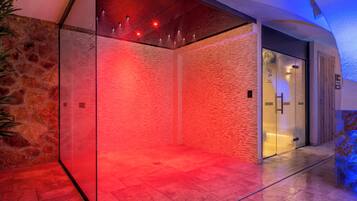 A modern elevator with a glass enclosure and a red-lit interior.