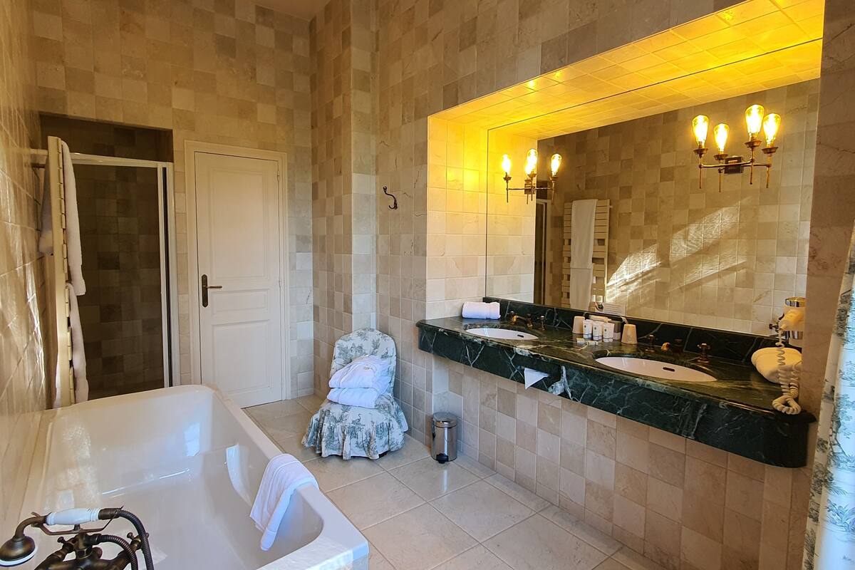 deluxe suite, 1 king bed with sofa bed, garden area | bathroom | designer toiletries, hair dryer, bathrobes, slippers