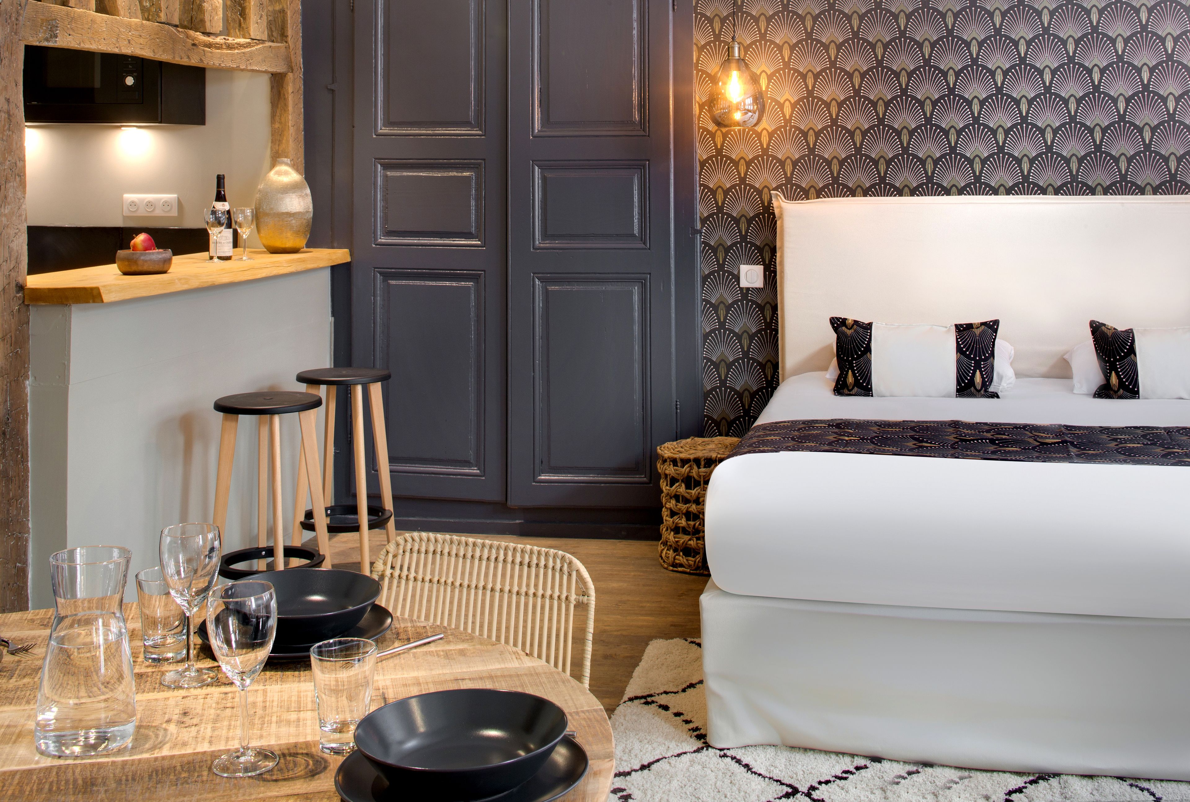 A bedroom with a bed, bedside tables, and a nightstand.