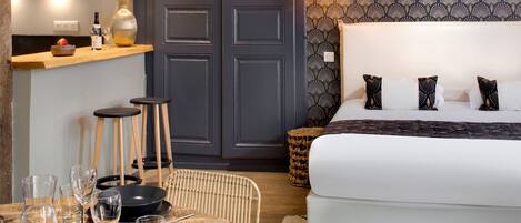 A bedroom with a bed, bedside tables, and a nightstand.