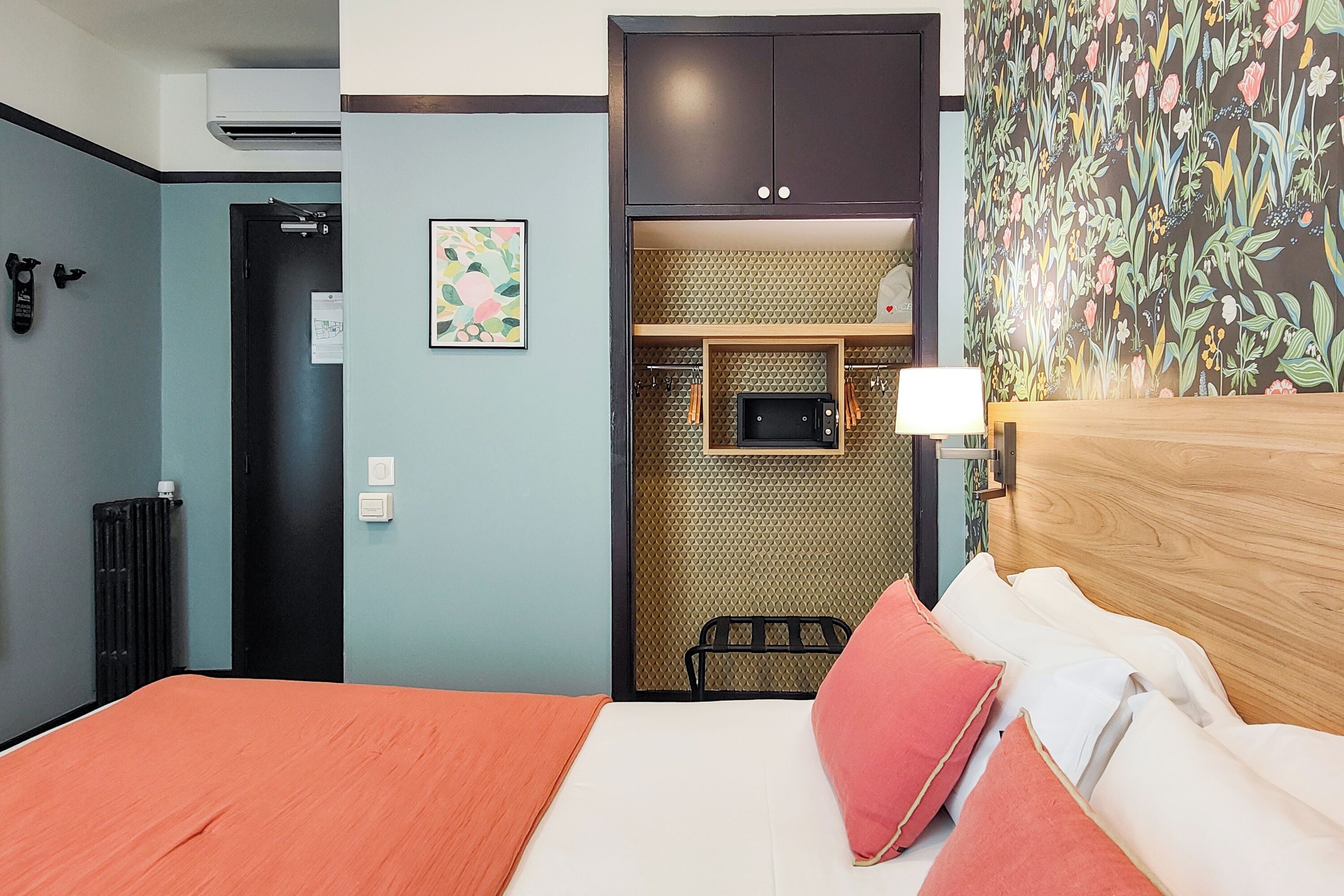 Habitación de hotel con cama, microondas, kitchenette pequeña y puerta que da a un baño.