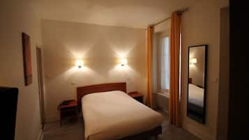 Comfortable accommodations feature a large bed, bedside tables, and a full-length mirror.