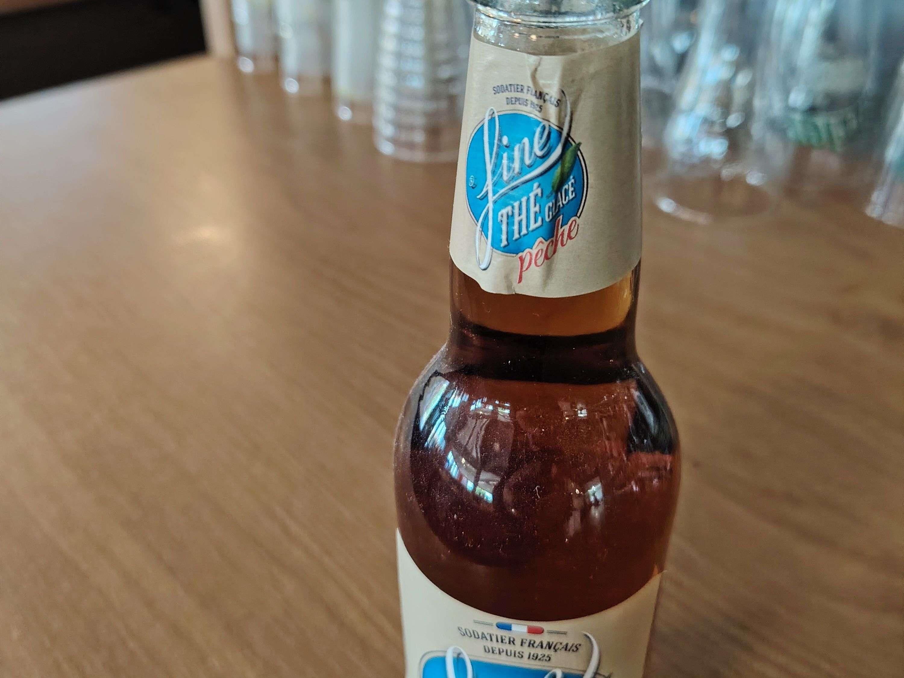 A bottle of Liqueur The Glace on a wooden table.
