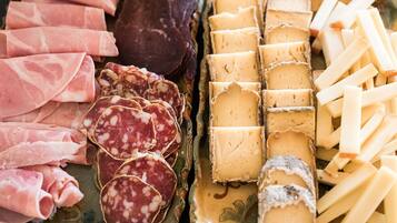 A variety of cured meats and cheeses on a platter.