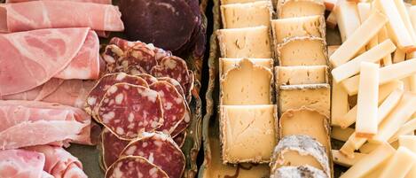 A variety of cured meats and cheeses on a platter.