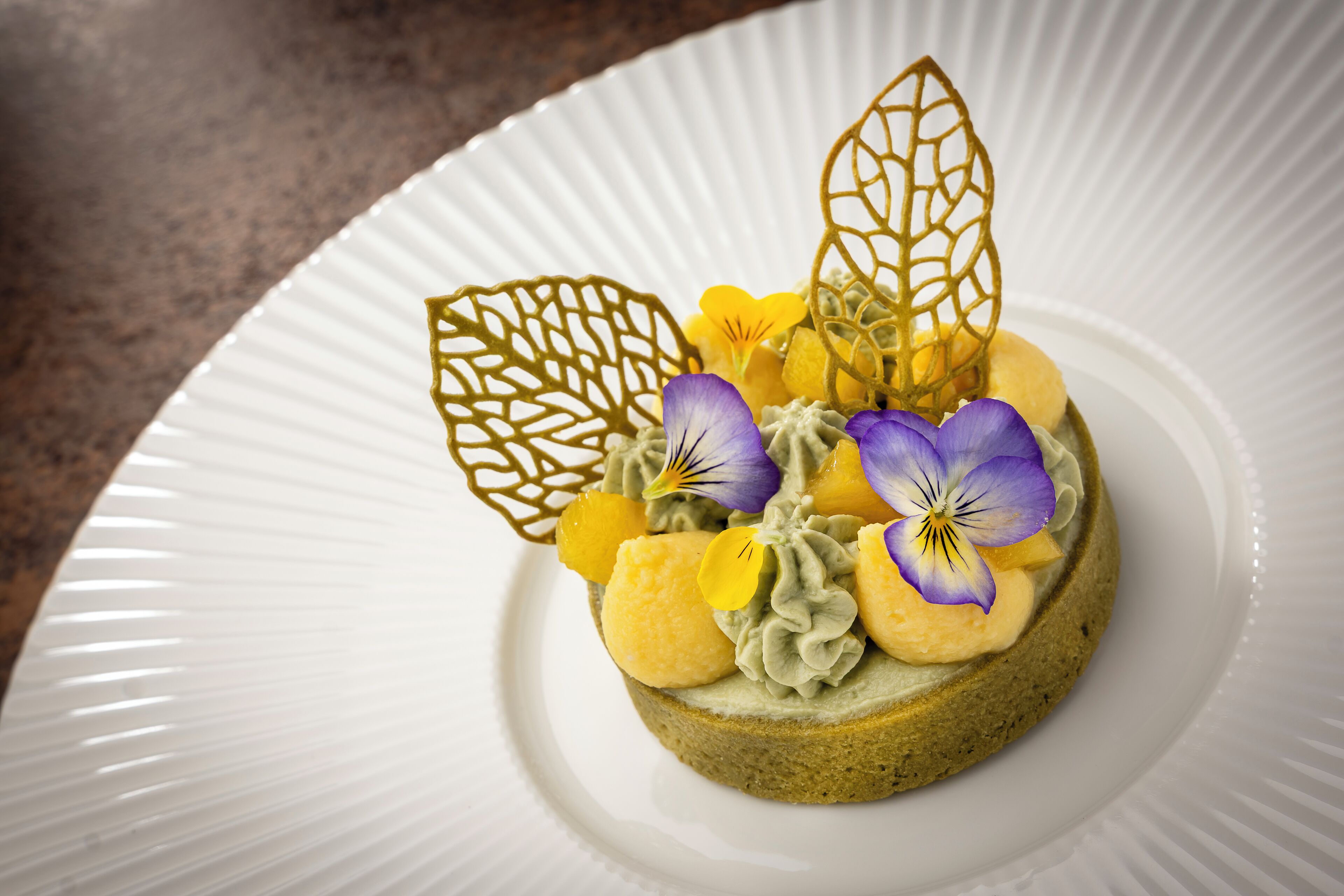 A dessert on a white plate with a textured rim.