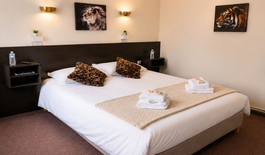 A hotel room with a large bed, two nightstands, a headboard, and wall-mounted artwork.