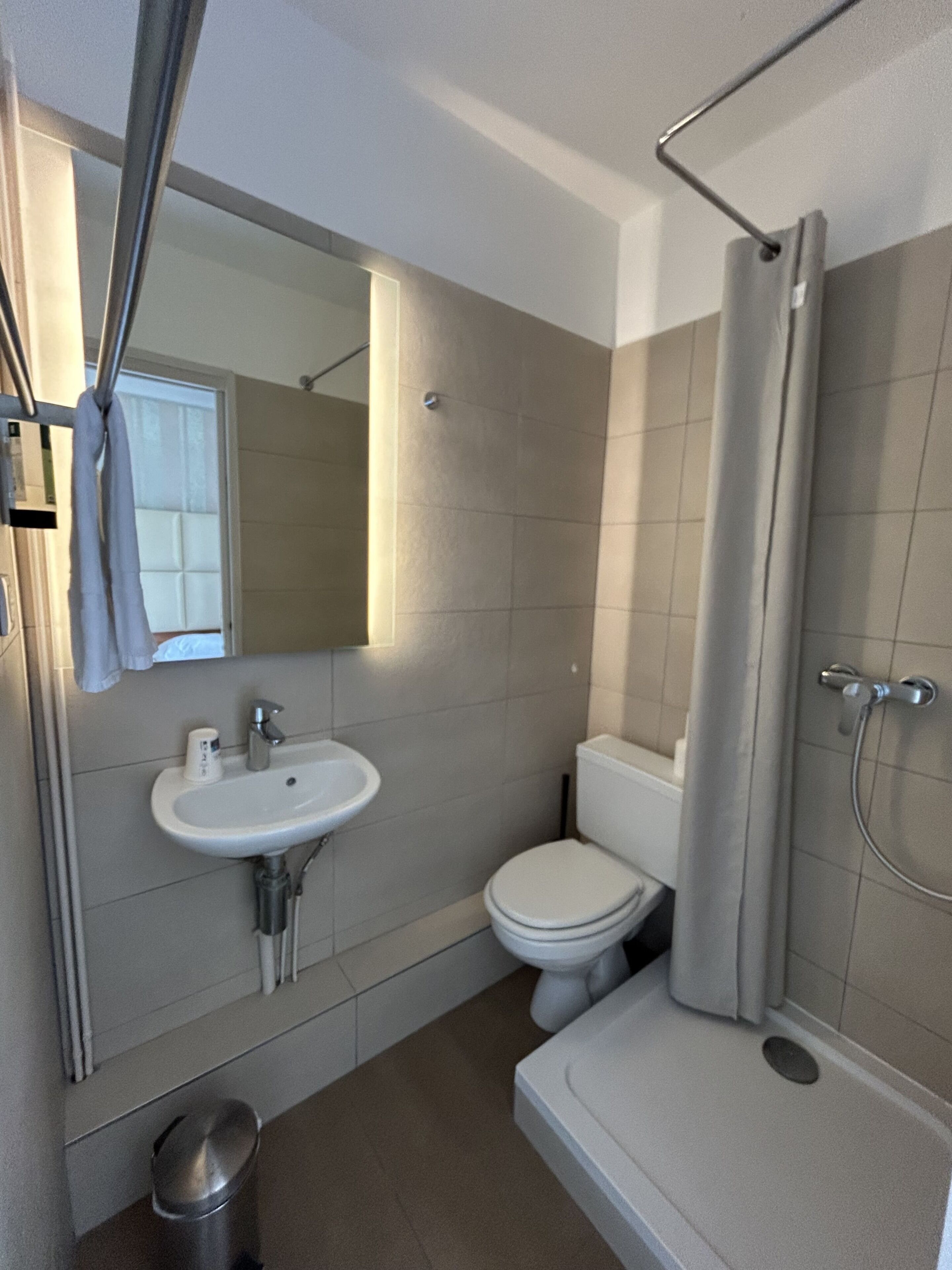 A bathroom with a sink, toilet, and shower.