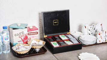 A breakfast buffet setup with various food items and beverages.