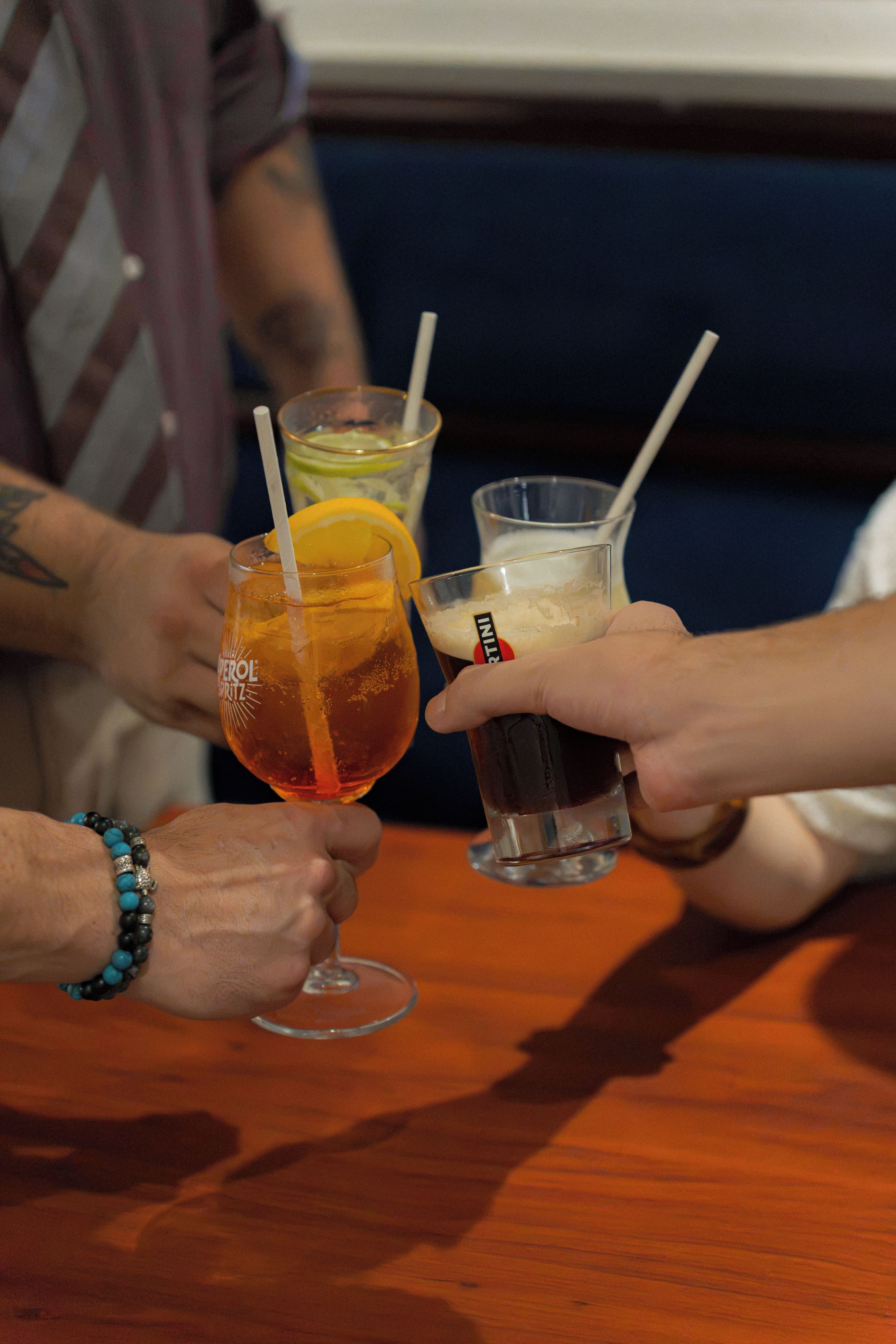 A group of people toasting with drinks at a table.