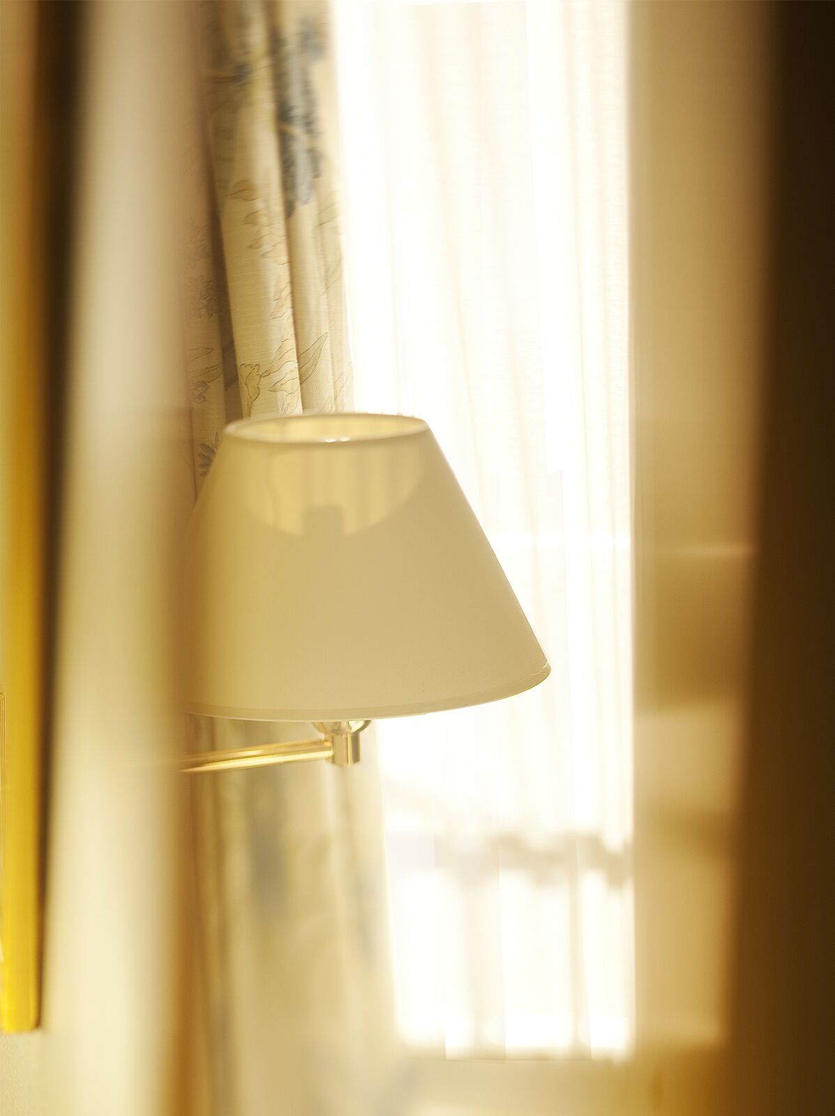Una lampada con un paralume bianco su una parete.
