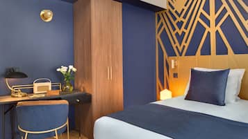 A bedroom with a bed, a desk with a chair, and a wardrobe.