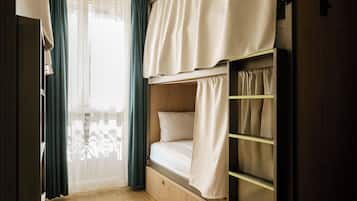 A bunk bed with a wooden headboard and a bedside table.