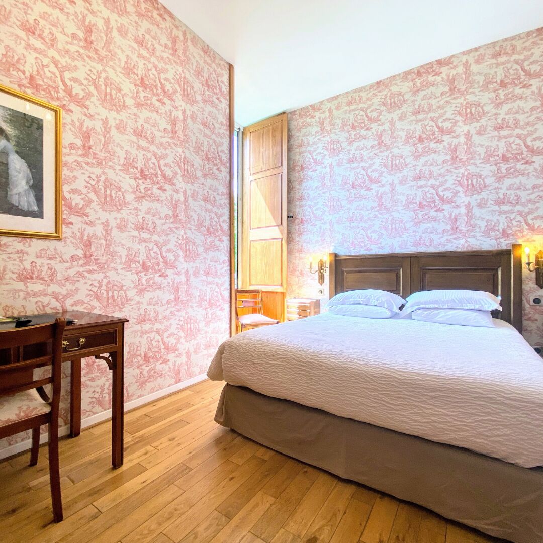 Ein Schlafzimmer mit einem Bett, einem Schreibtisch und einem Stuhl.