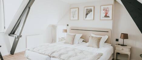 Una camera da letto con un letto, comodini e decorazioni alle pareti.