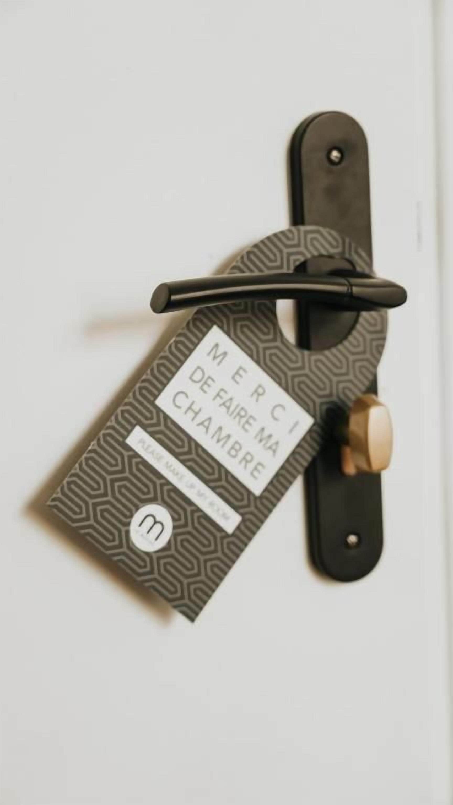 A door with a metal handle and a door card with a pattern and text.