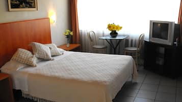 Desk, iron/ironing board, bed sheets